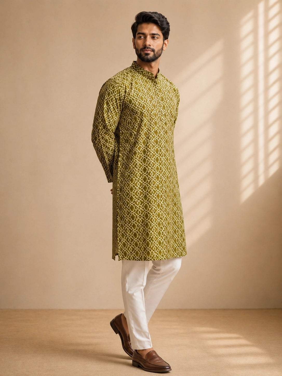 Man in a green patterned kurta with a band collar and white pajama.