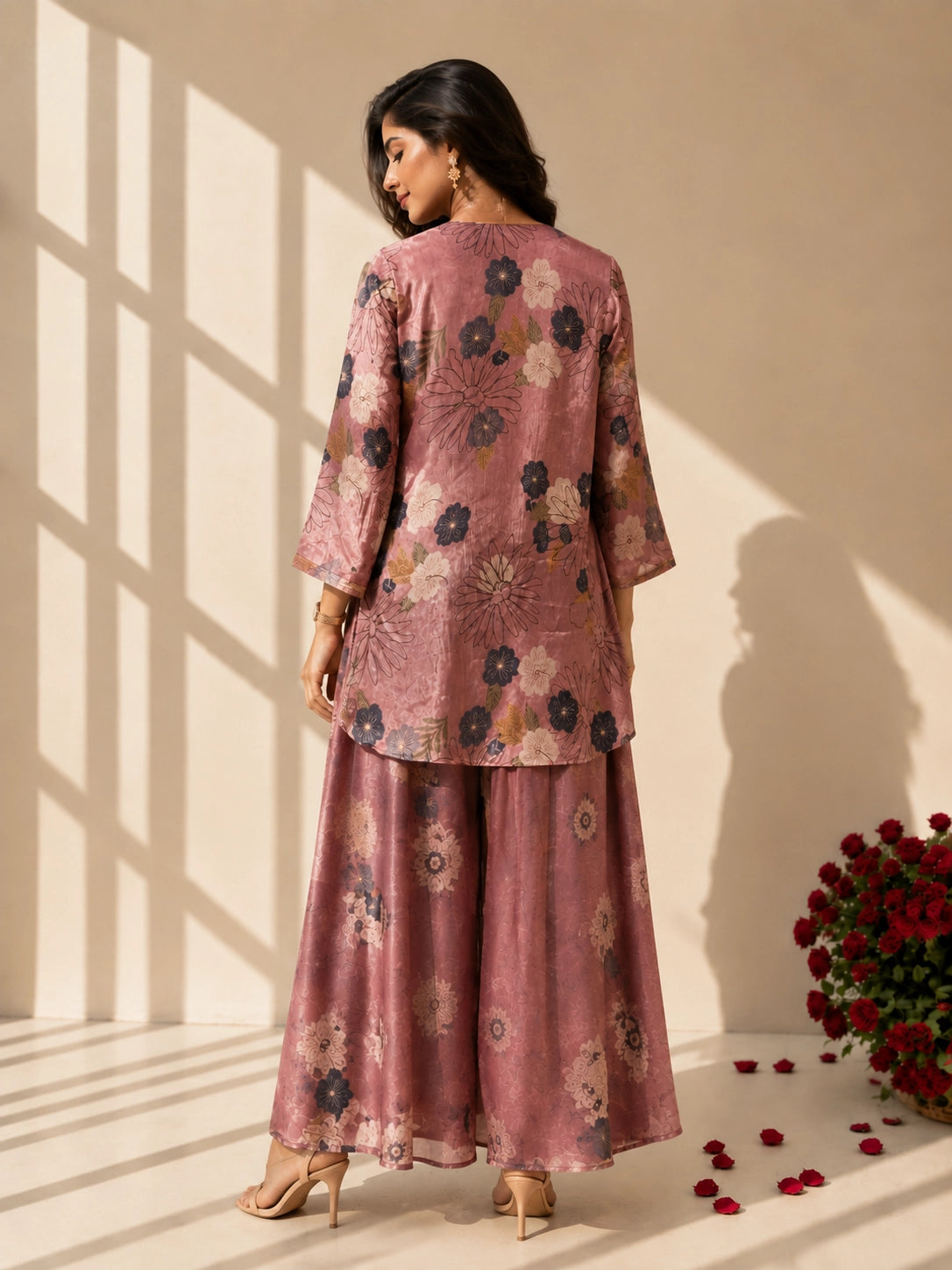 Woman in an elegant peach floral kurti set with palazzo pants and matching dupatta.