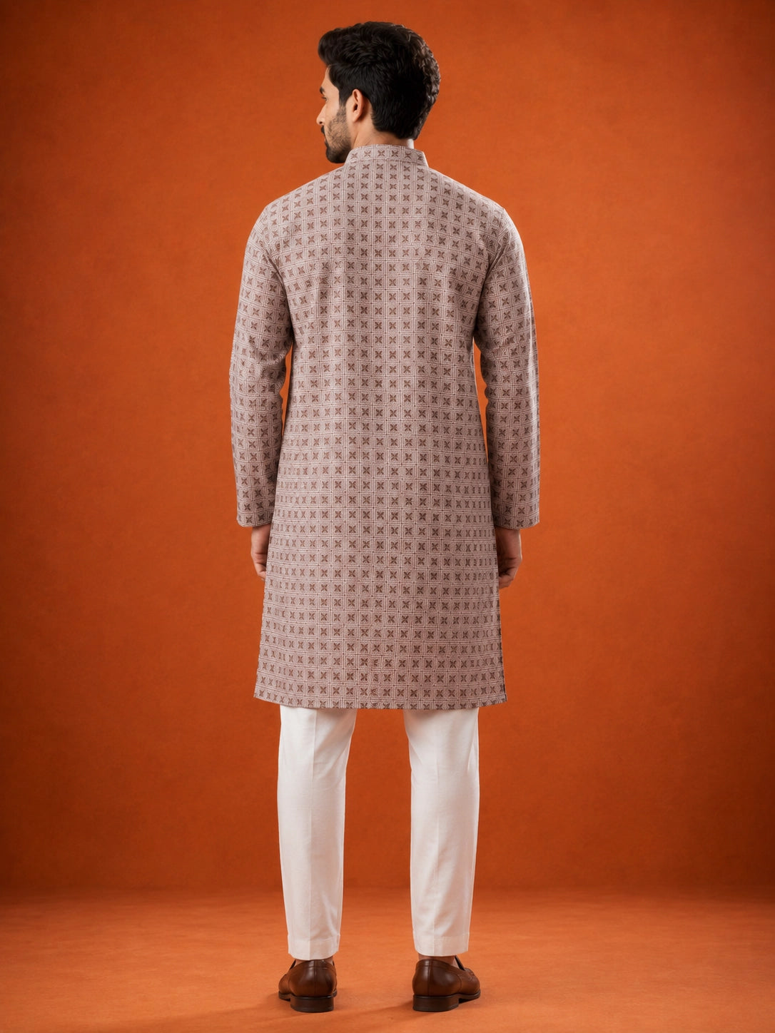 Man wearing P.IVORY geometric print kurta with white pajama and brown loafers.