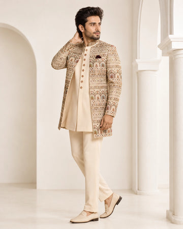 Man wearing an elegant beige Sherwani, showcasing intricate embroidery and a classic fit for formal events.