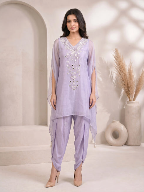 Woman wearing a light purple embroidered kaftan with split sleeves and matching dhoti pants, adorned with mirror work.