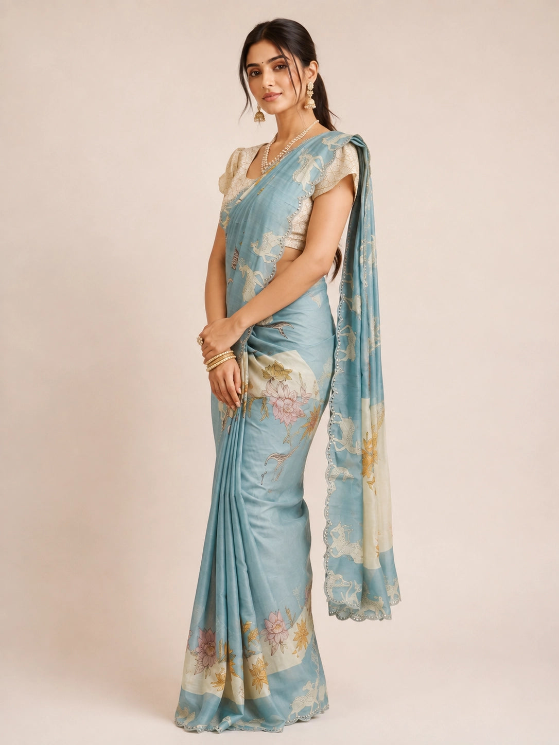 Woman in an elegant sky blue  floral saree with a cream textured blouse.