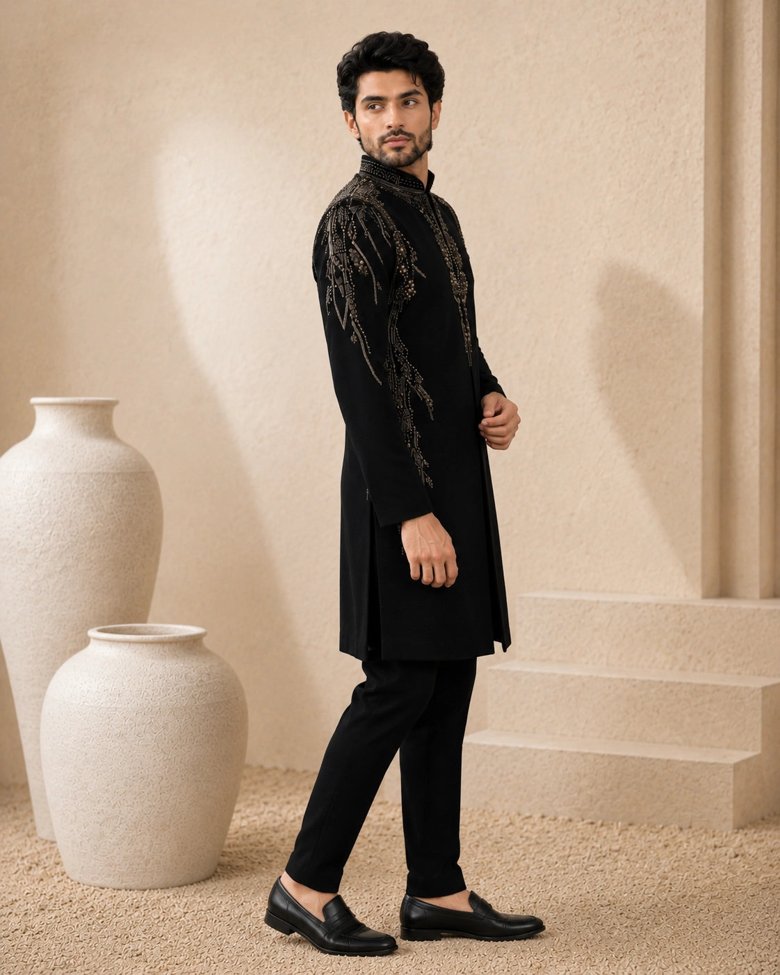 Man wearing a stylish black Indo-Western suit, showcasing intricate details and a modern fit.