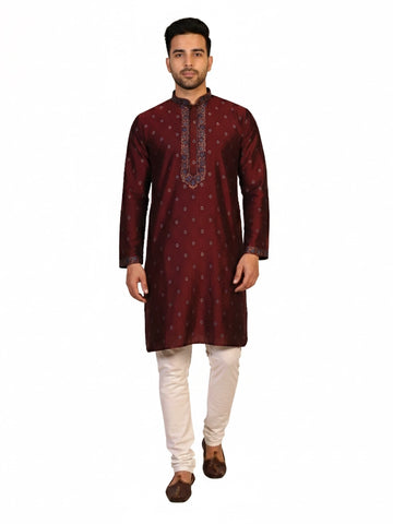 Man wearing a maroon kurta with a diamond pattern and embroidered neckline, paired with cream pants.