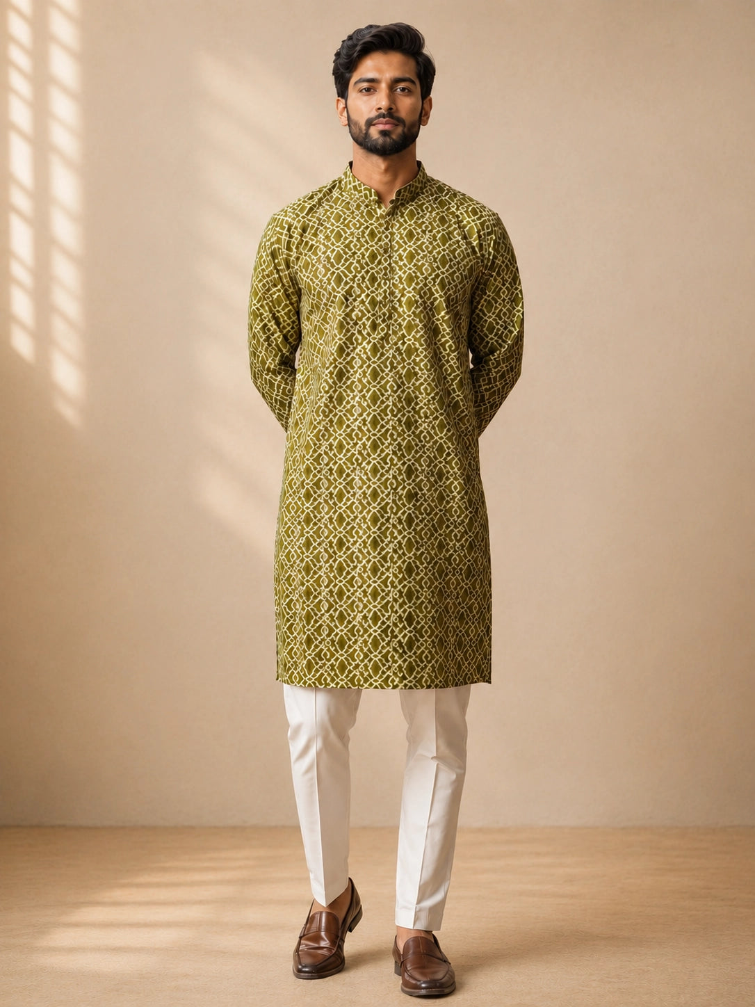 Man in a green patterned kurta with a band collar and white pajama.