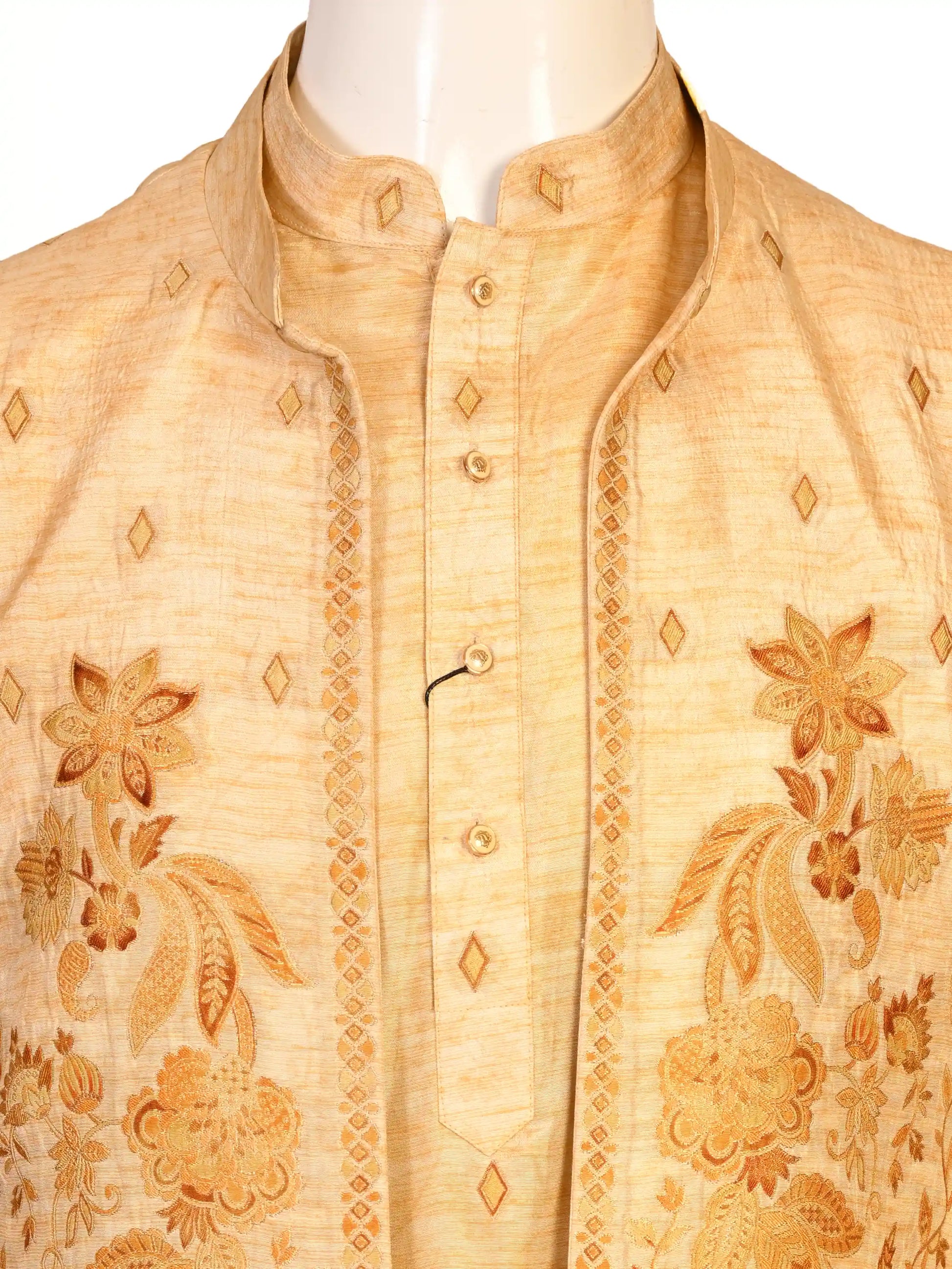 Man wearing a beige embroidered kurta jacket set with golden floral patterns, suitable for festive occasions.