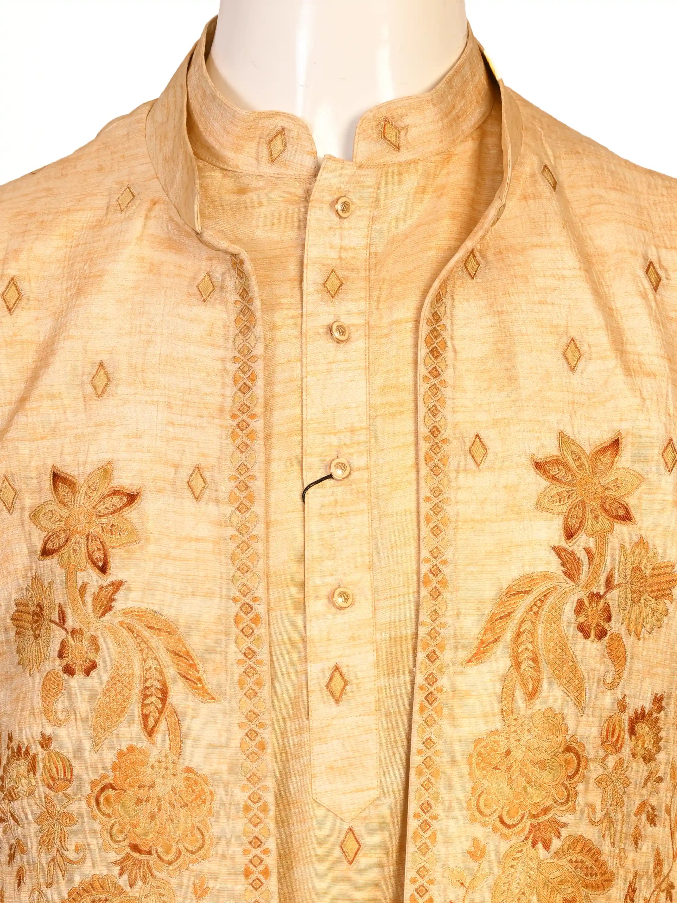 Man wearing a beige embroidered kurta jacket set with golden floral patterns, suitable for festive occasions.