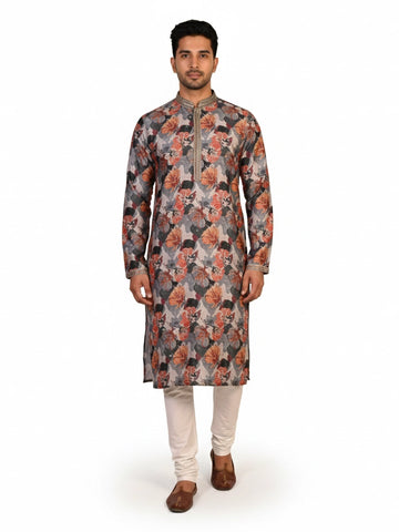 Man wearing a multi-color floral print kurta with an embellished neckline and cream churidar pants.