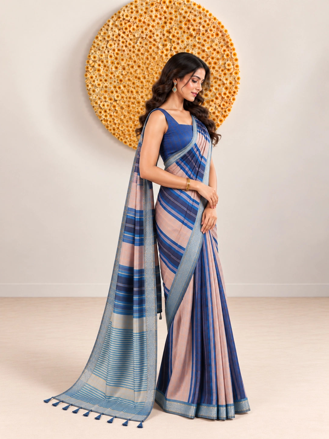 Woman in an elegant blue and pink striped saree with a detailed border.