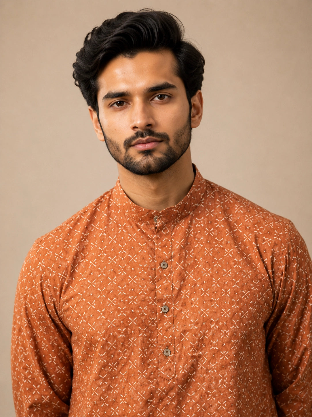Man wearing a brown printed kurta with a band collar and white pajama.