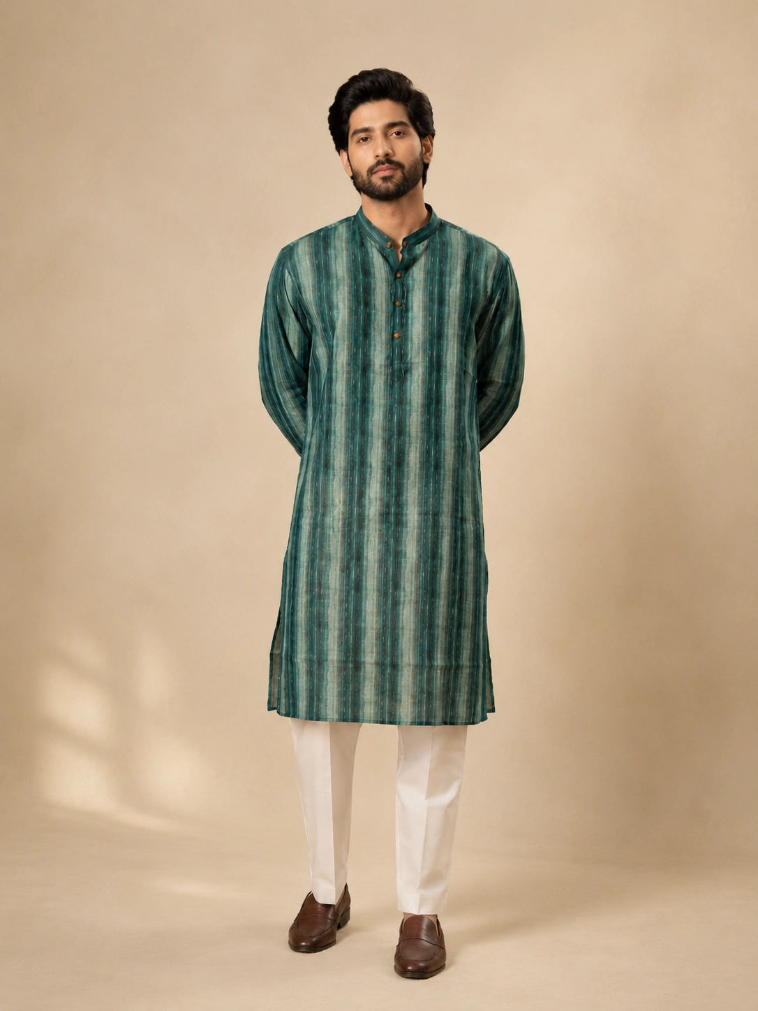 Man wearing a C.Teal striped kurta with white pajama and brown loafers.