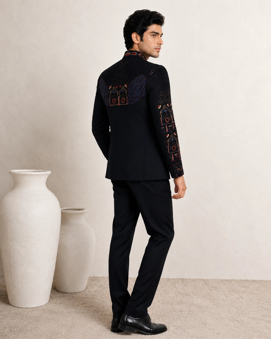 Man wearing an elegant navy blue Jodhpuri suit, a traditional Indian formal outfit.