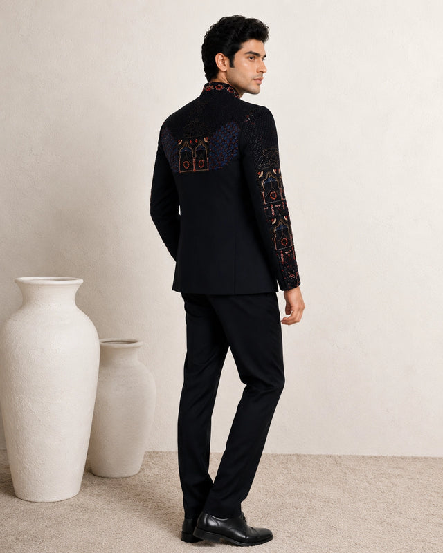 Man wearing an elegant navy blue Jodhpuri suit, a traditional Indian formal outfit.