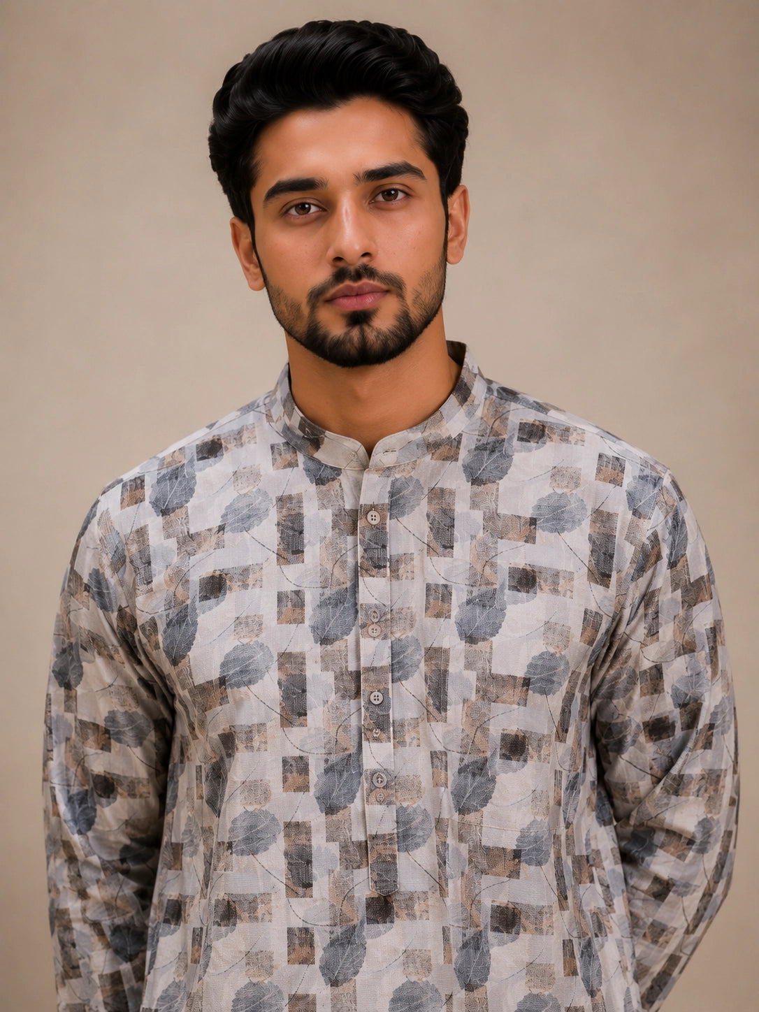 Man wearing an ice grey printed kurta with white pajama and brown loafers.