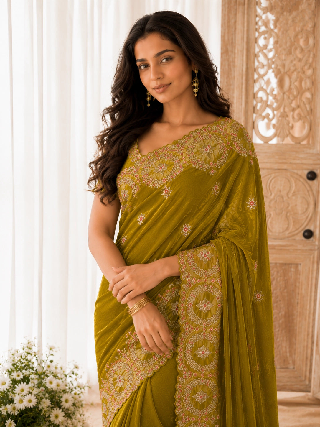 Woman wearing an elegant mustard velvet  saree with intricate embroidery.