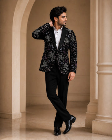 A classic black taxido suit, perfect for formal events, showcasing elegant tailoring and a sophisticated look.