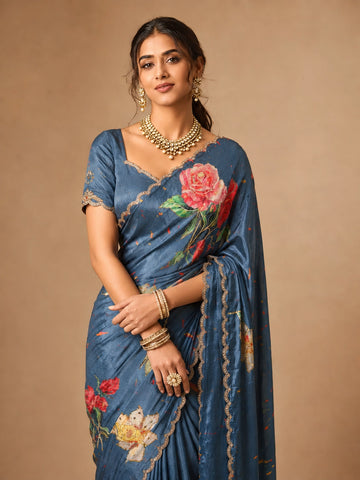 Woman wearing an elegant SKY blue  floral printed saree with a scalloped border.