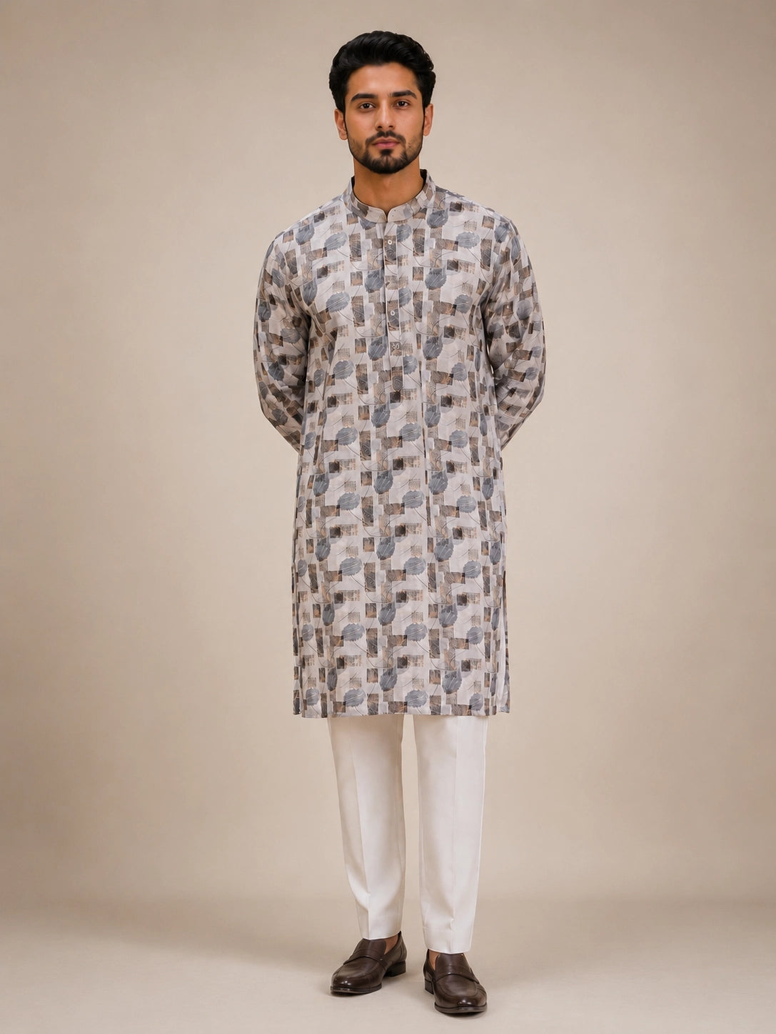Man wearing an ice grey printed kurta with white pajama and brown loafers.