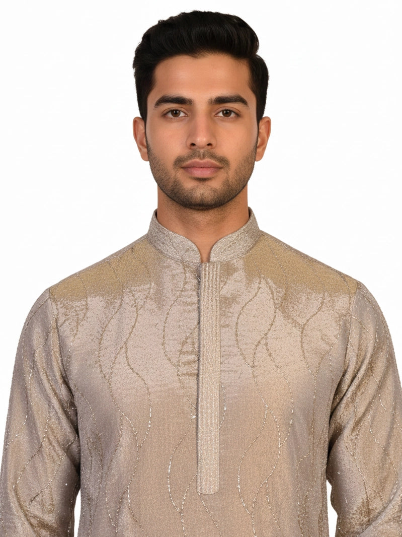 Man wearing a multi-color textured kurta with shimmering accents and cream pants, ready for festive occasions.
