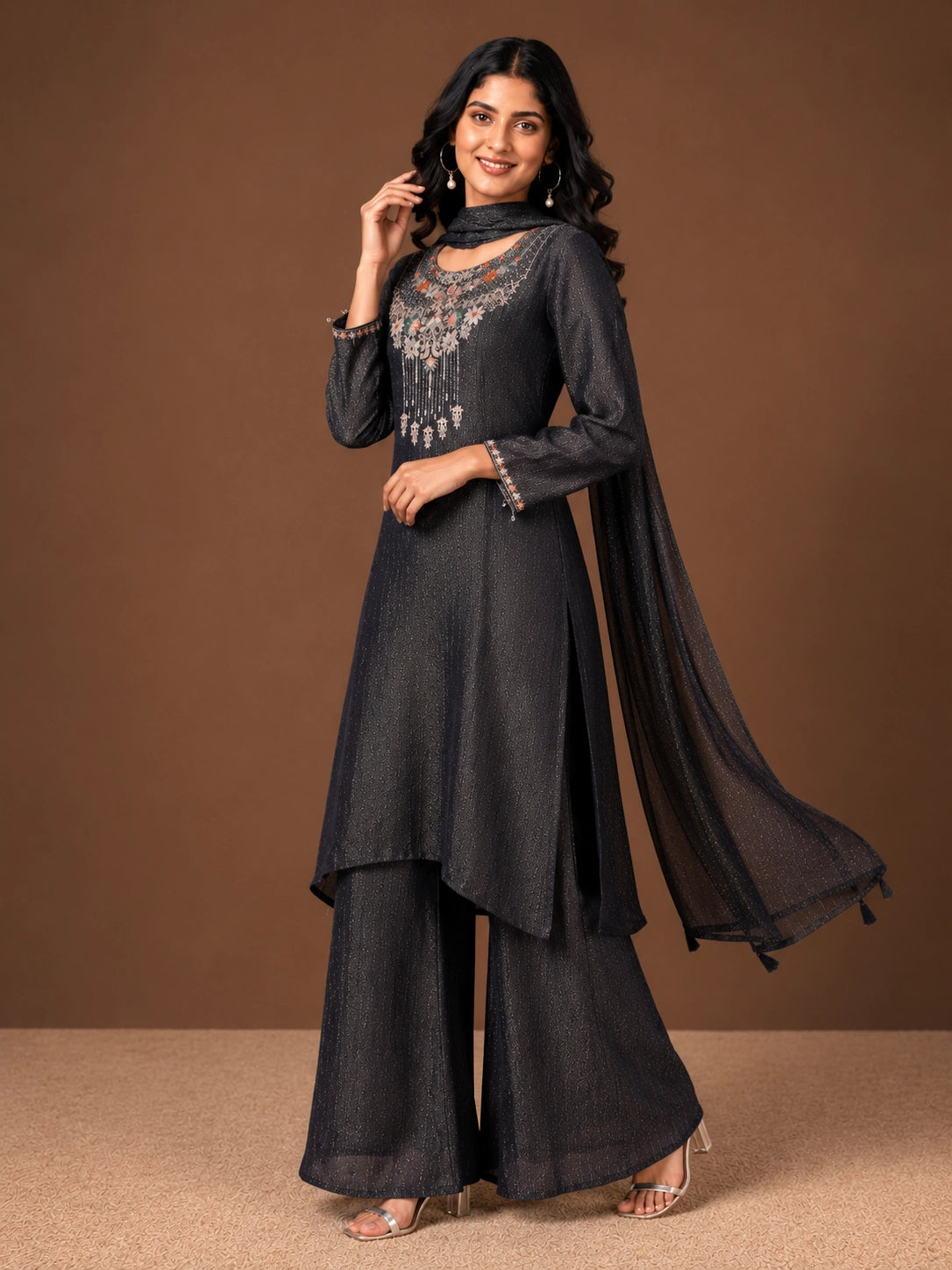 Woman wearing a Fawn sparkling embroidered Sharara with intricate floral details on the neckline and cuffs.