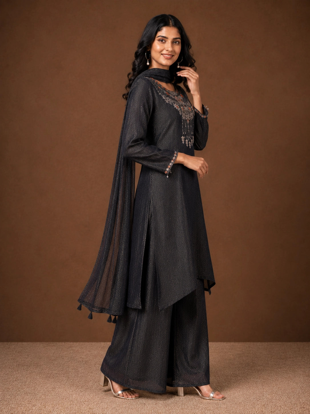 Woman wearing a Fawn sparkling embroidered Sharara with intricate floral details on the neckline and cuffs.