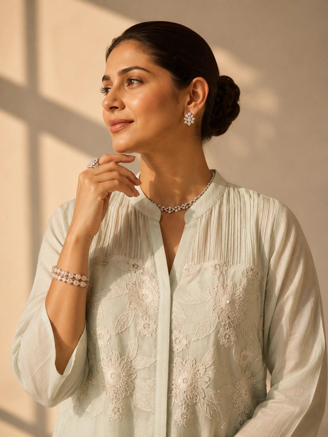 Woman in an elegant pista green embroidered tunic and wide-leg palazzo set.