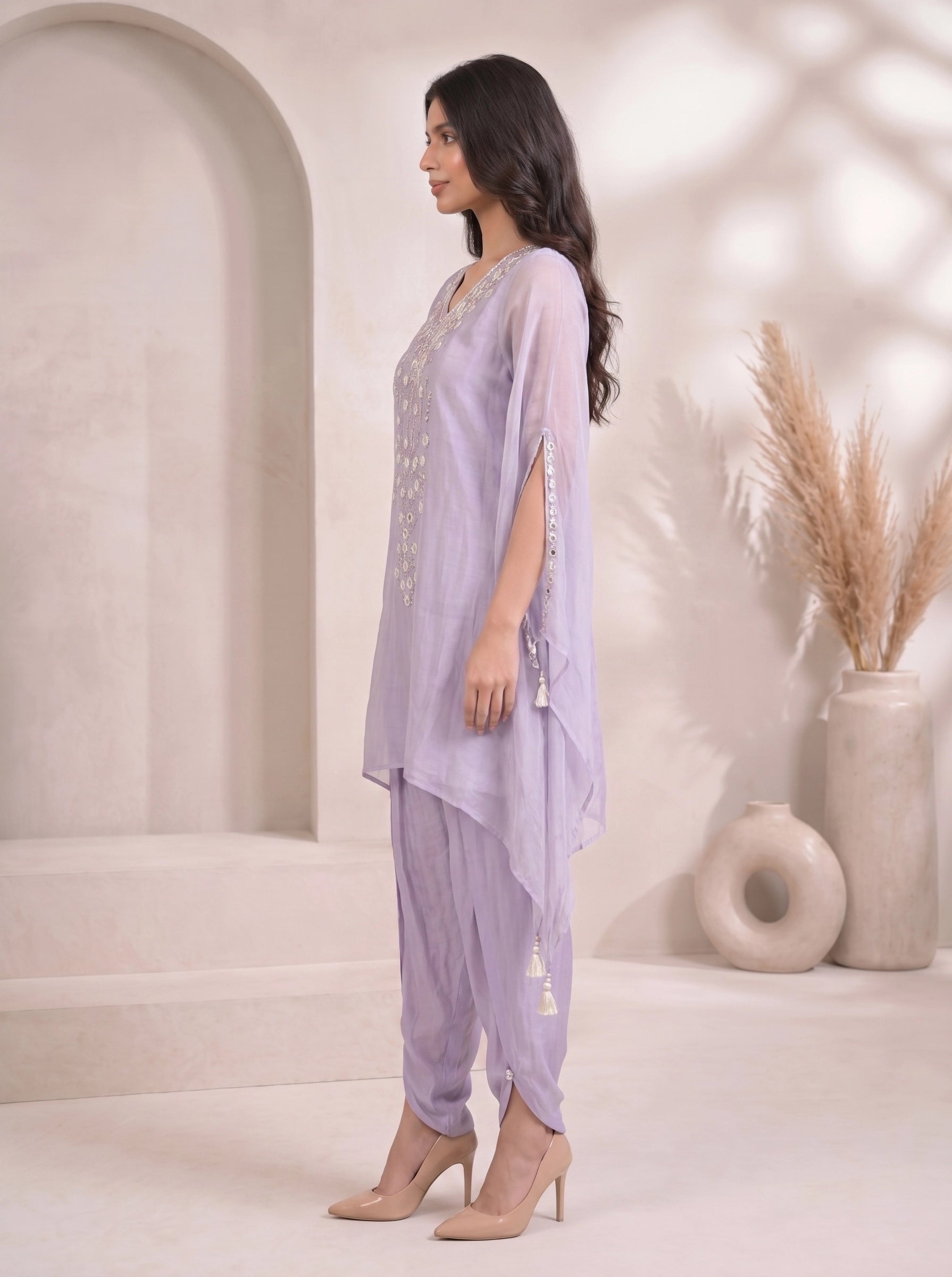 Woman wearing a light purple embroidered kaftan with split sleeves and matching dhoti pants, adorned with mirror work.