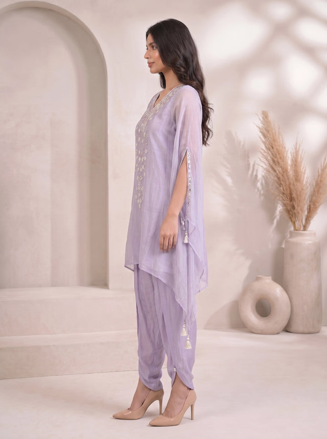 Woman wearing a light purple embroidered kaftan with split sleeves and matching dhoti pants, adorned with mirror work.