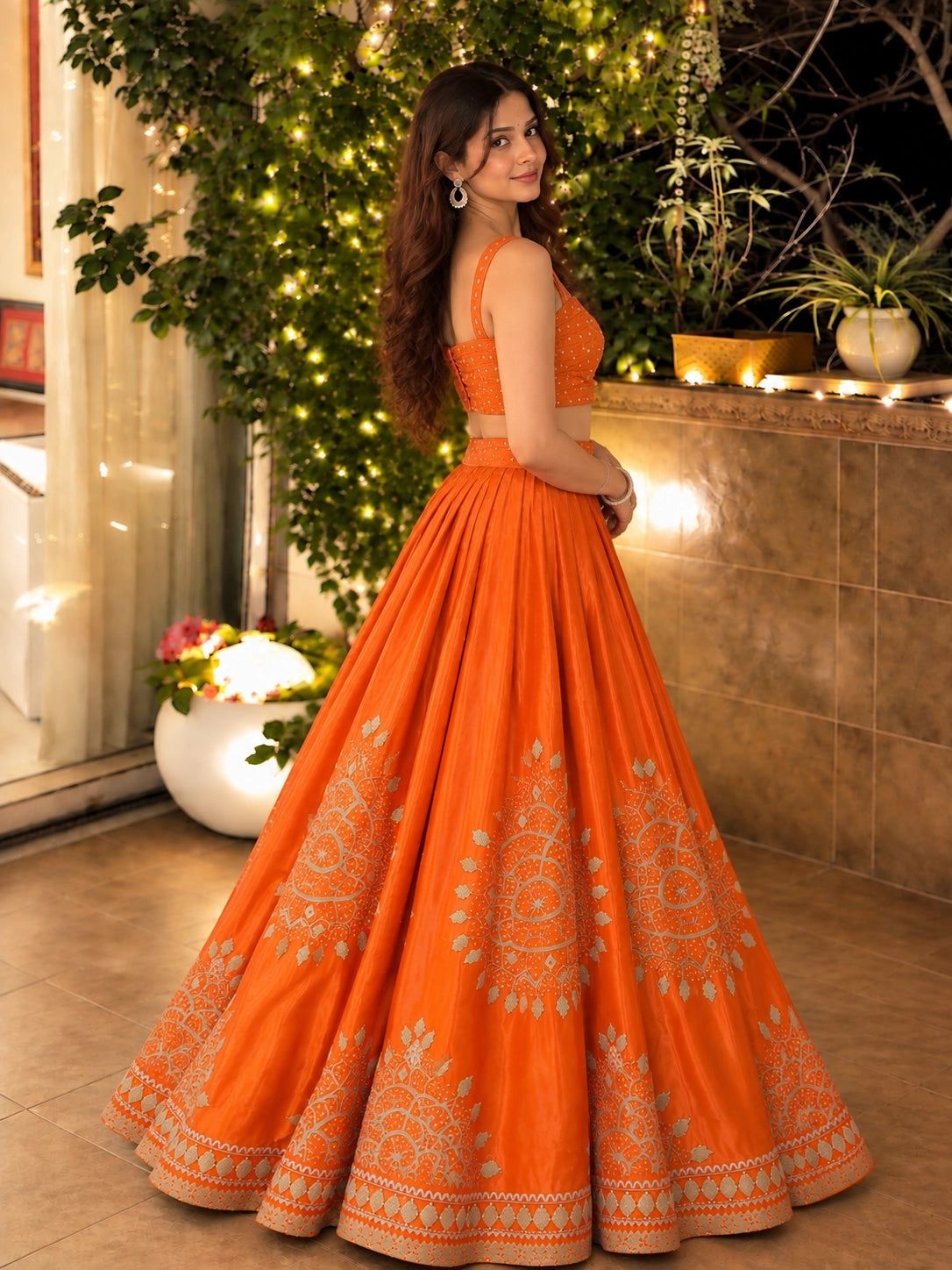 Woman in elegant rust embroidered lehenga choli set with matching dupatta.