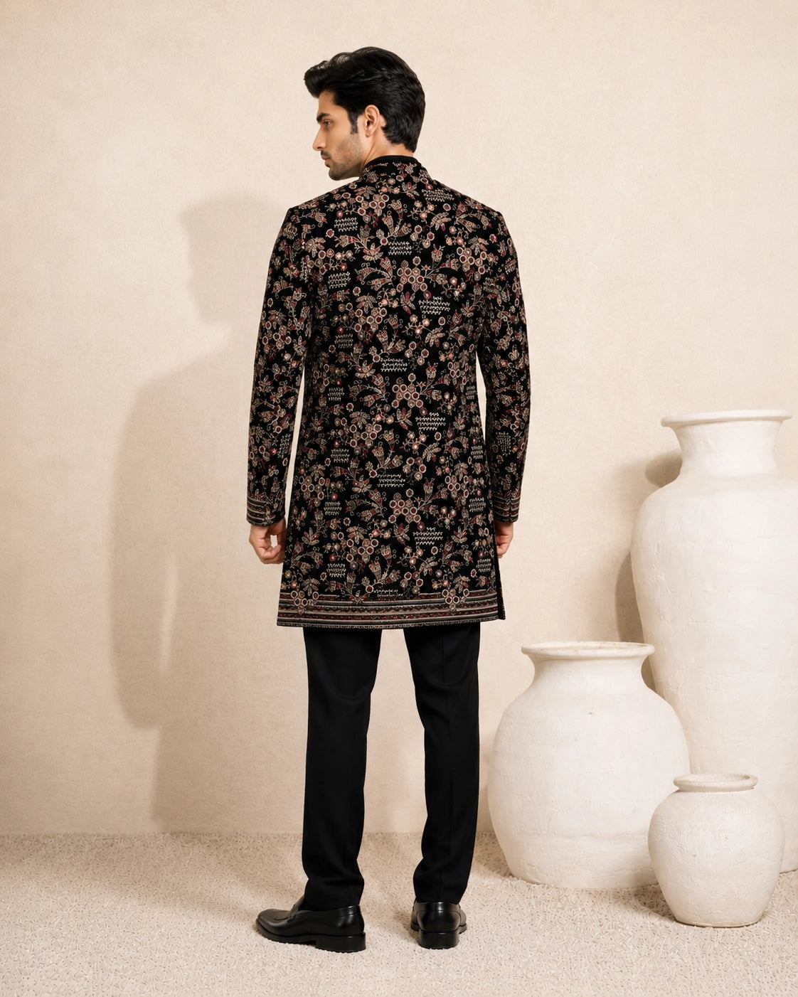 Man wearing a stylish black Indo-Western suit, showcasing modern Indian ethnic wear.