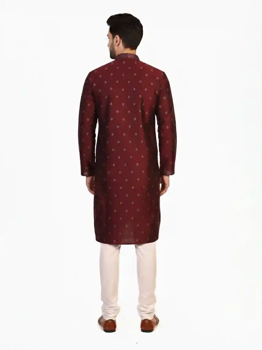 Man wearing a maroon kurta with a diamond pattern and embroidered neckline, paired with cream pants.
