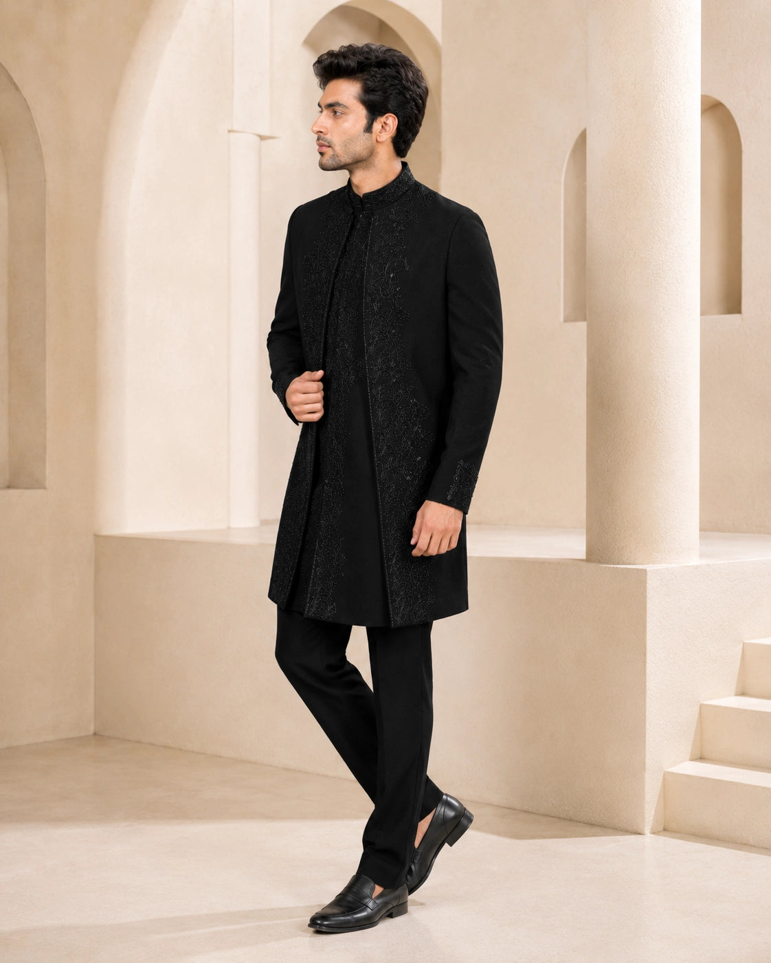 Man wearing a stylish black Indo-Western suit, perfect for formal events and celebrations.