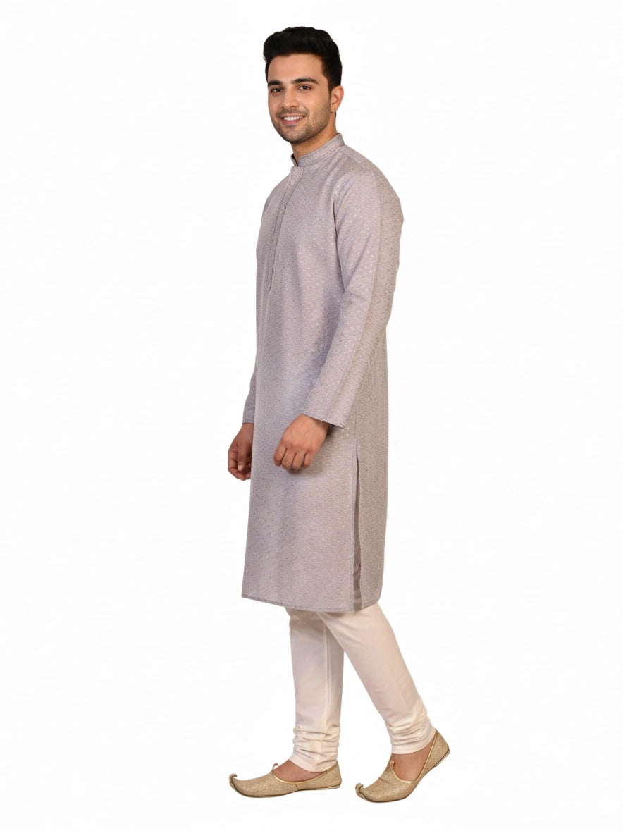 Man wearing a grey Kurta Pajama with a subtle geometric pattern and cream churidar pants.