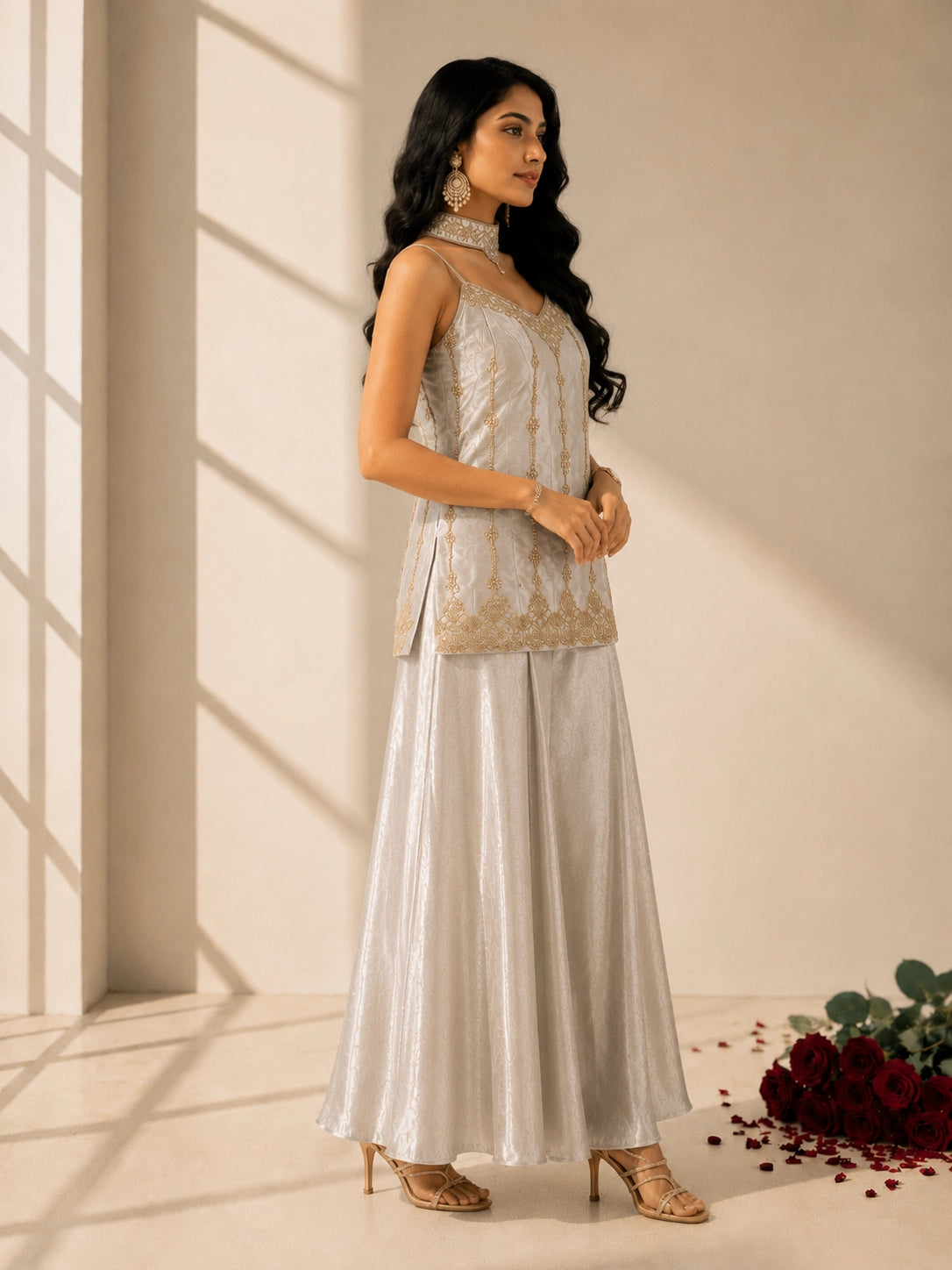 Woman in elegant grey sleeveless kurti with gold embroidery and matching palazzo pants.