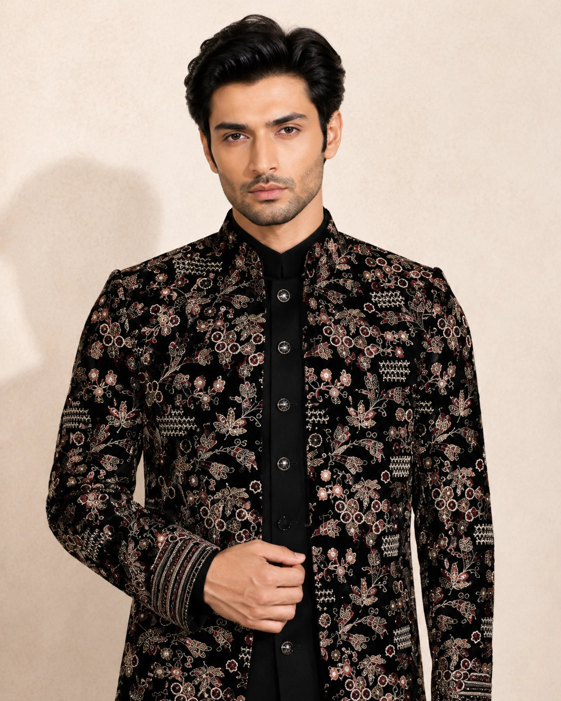 Man wearing a stylish black Indo-Western suit, showcasing modern Indian ethnic wear.