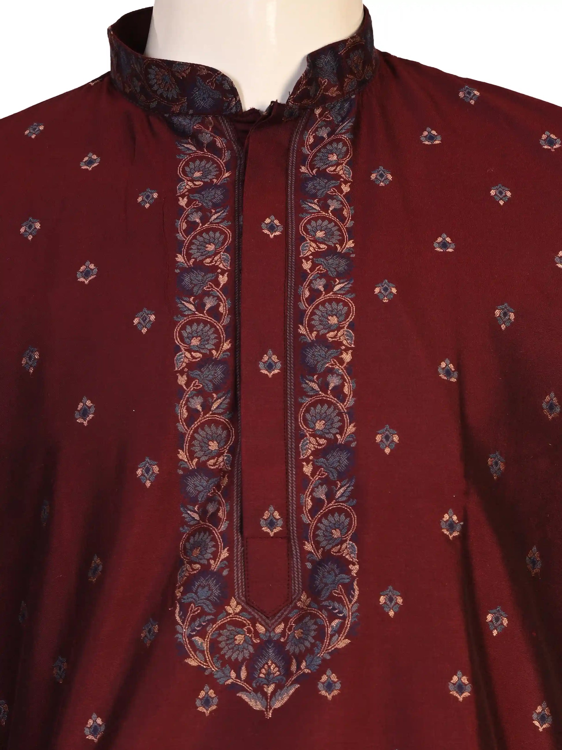 Man wearing a maroon kurta with a diamond pattern and embroidered neckline, paired with cream pants.