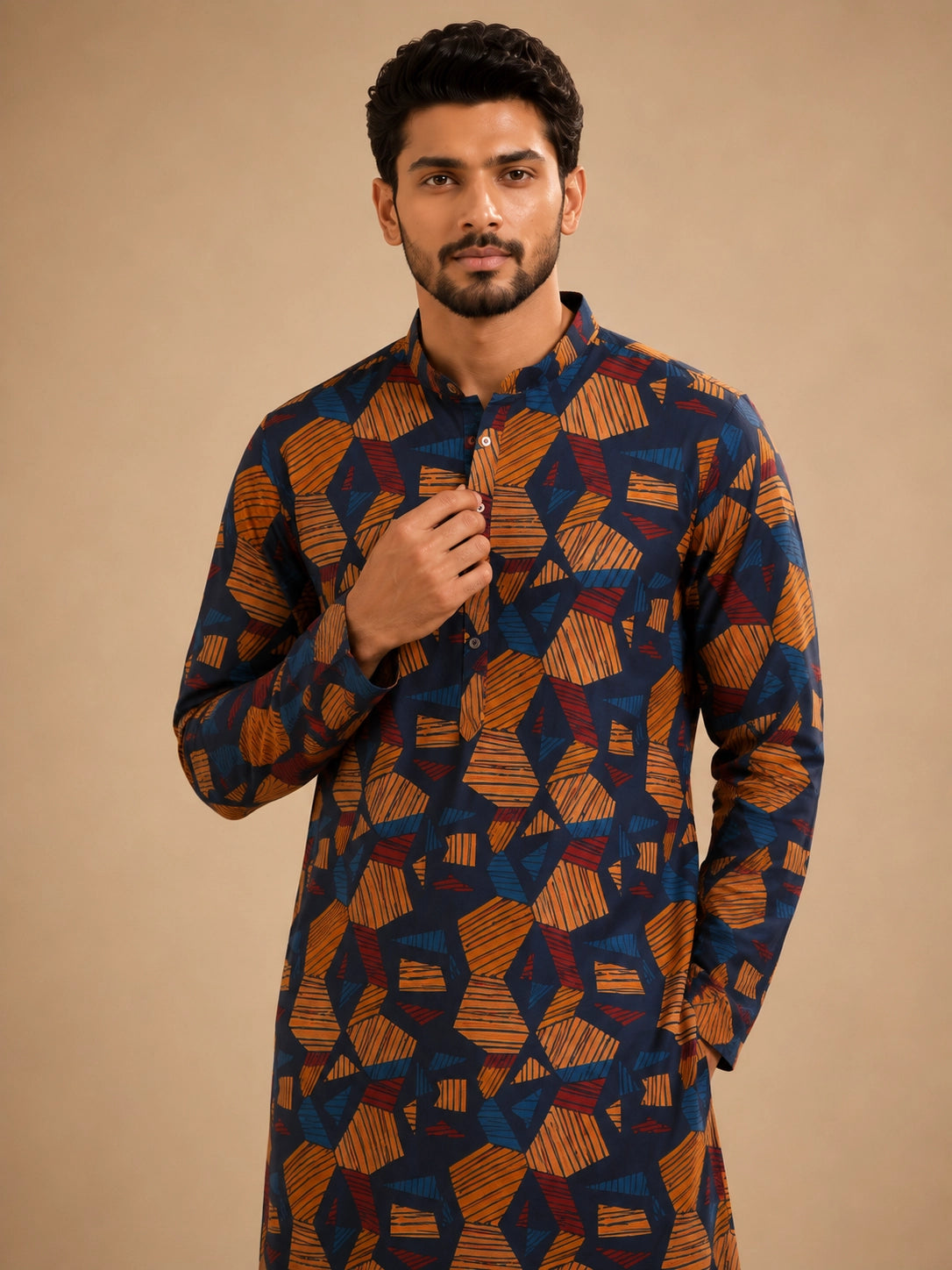 Men's navy kurta with geometric print, paired with white pajama bottoms and brown sandals.