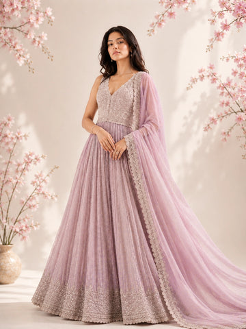 Model in a luxurious pink embroidered Anarkali gown with a flowing dupatta.