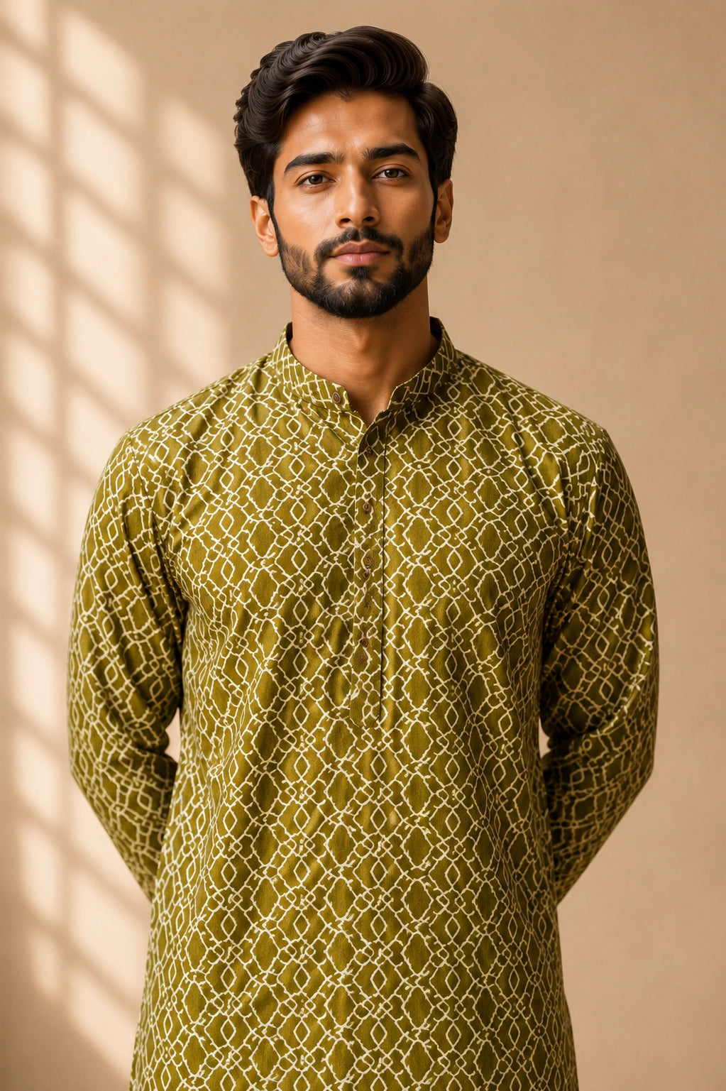 Man in a green patterned kurta with a band collar and white pajama.