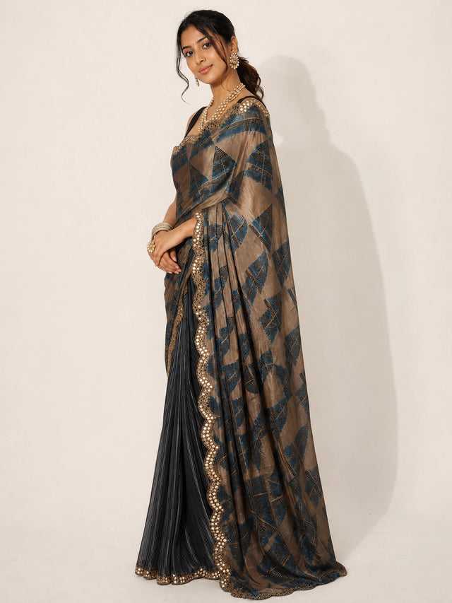 Woman in elegant grey and bronze  saree with geometric patterns and embellished border.