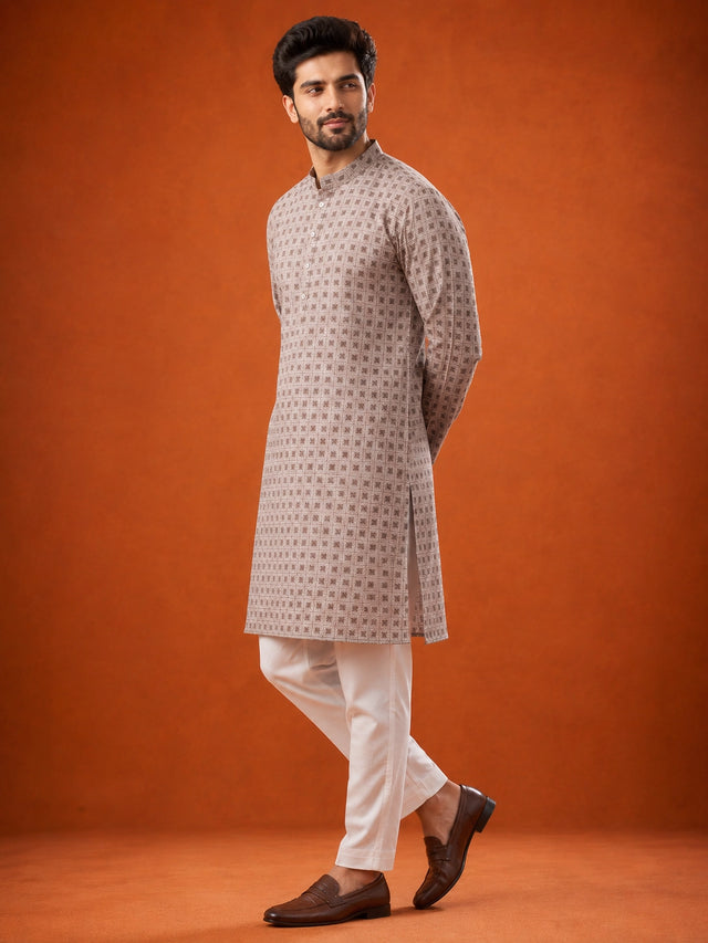 Man wearing P.IVORY geometric print kurta with white pajama and brown loafers.