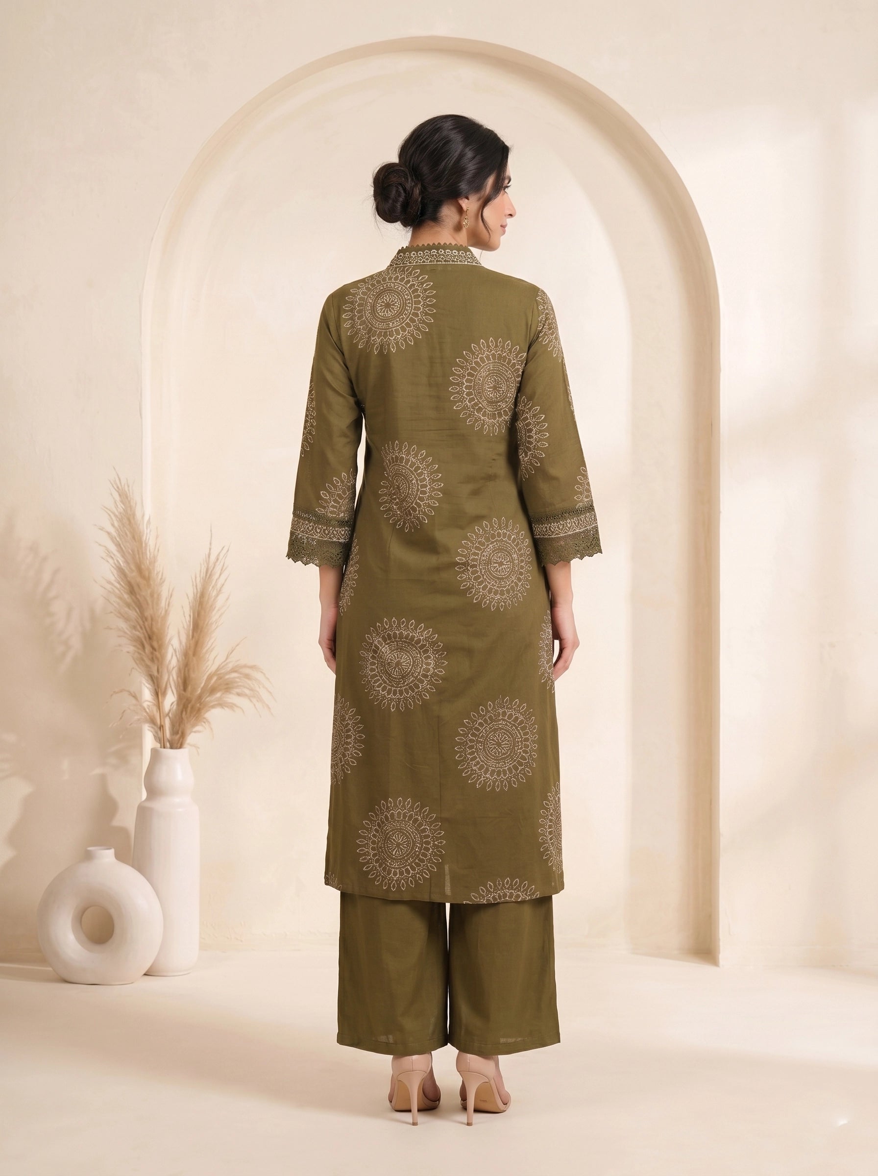 Woman wearing an olive green printed kurti with palazzo pants and a dupatta, styled for a casual or festive occasion.
