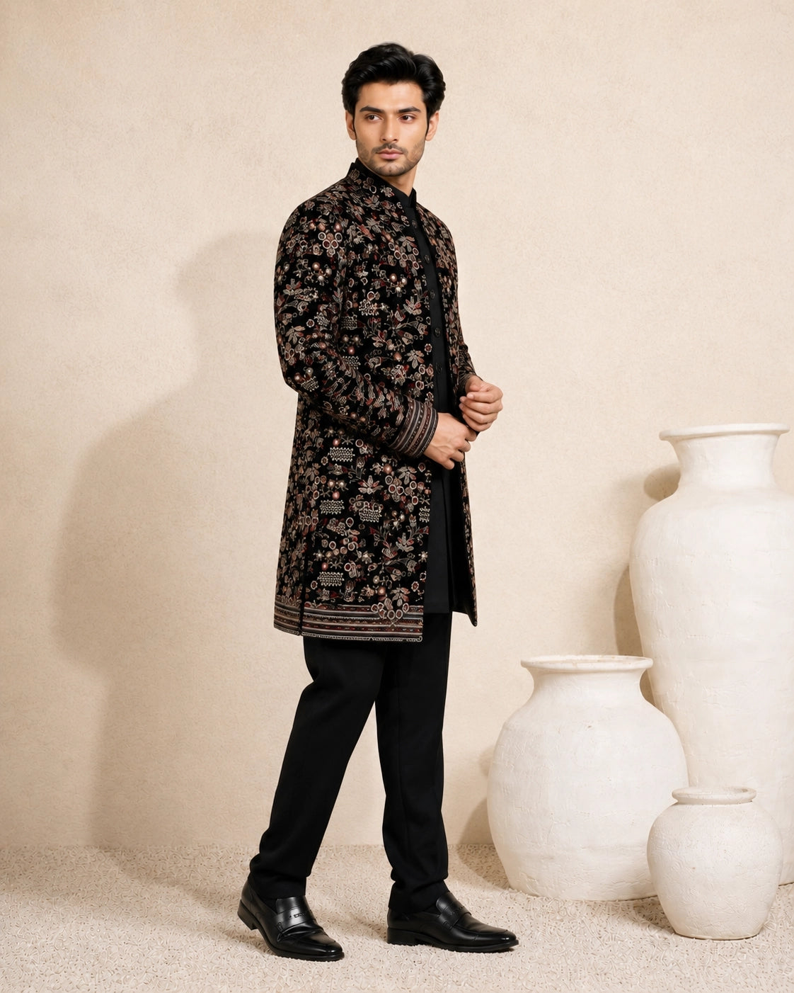 Man wearing a stylish black Indo-Western suit, showcasing modern Indian ethnic wear.