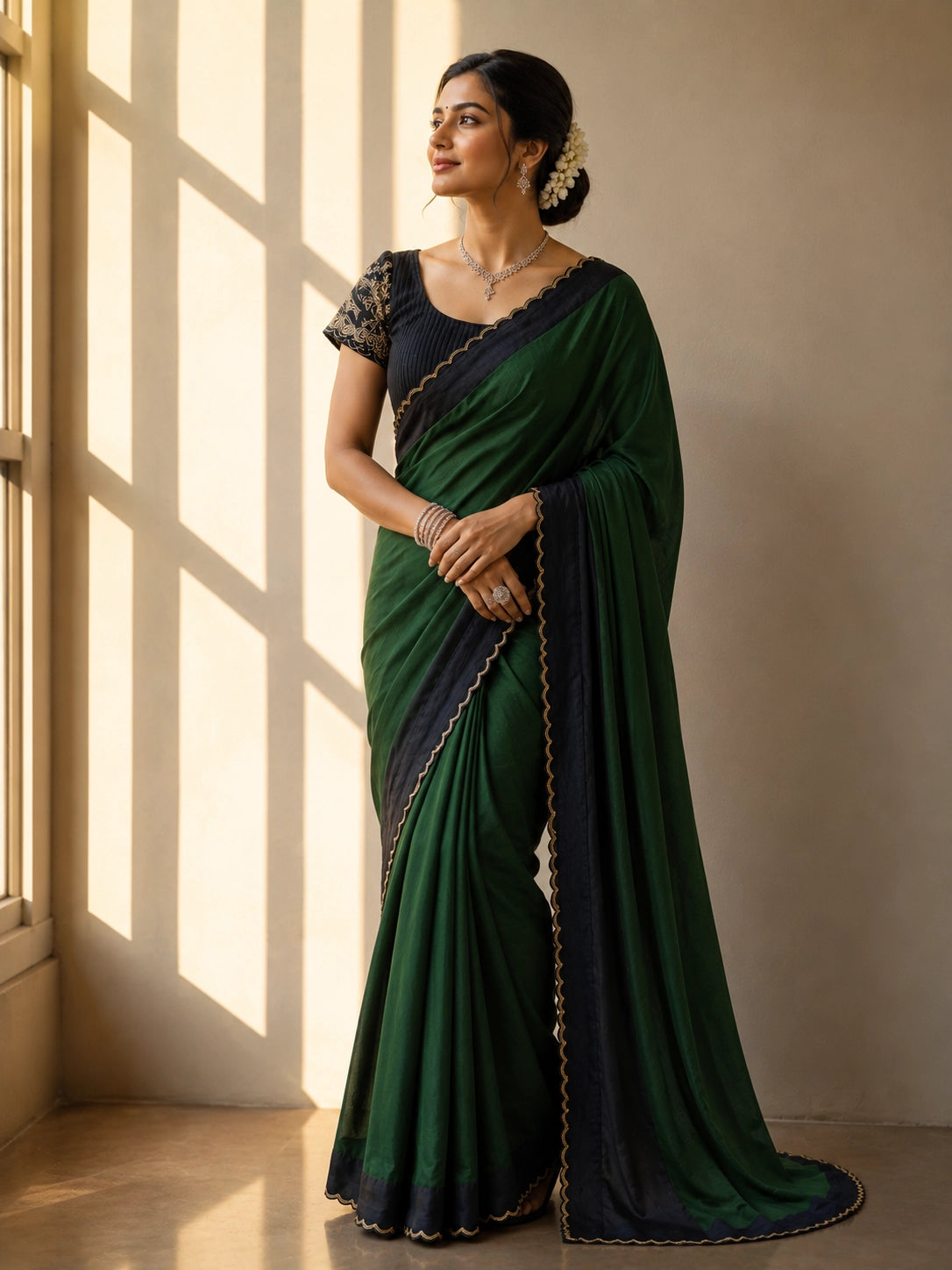Elegant saree in grey with black scalloped border and gold trim.