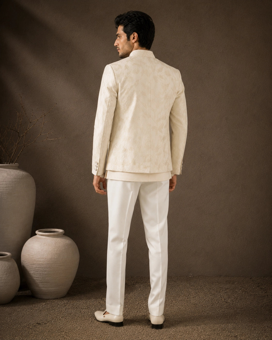 Man wearing a classic white Jodhpuri suit, perfect for formal Indian events and celebrations.