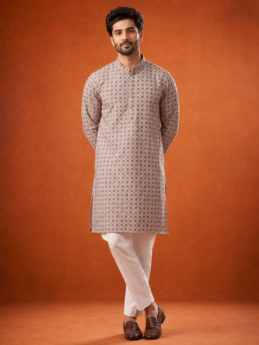 Man wearing P.IVORY geometric print kurta with white pajama and brown loafers.