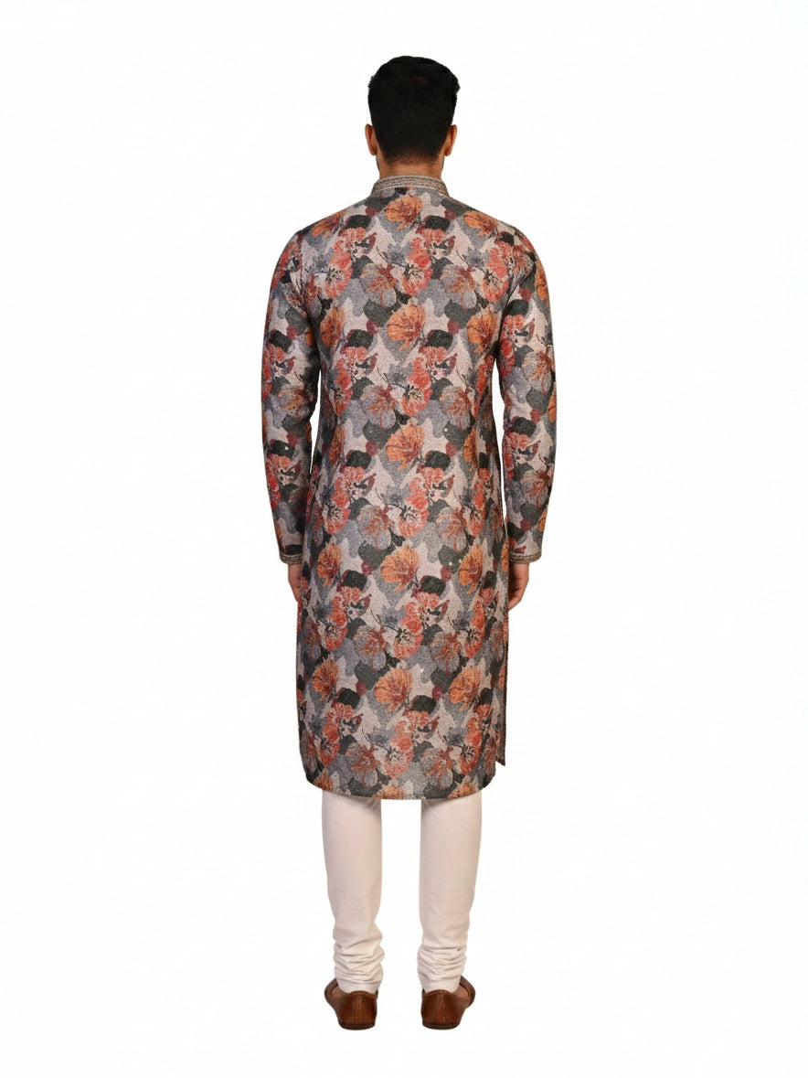 Man wearing a multi-color floral print kurta with an embellished neckline and cream churidar pants.