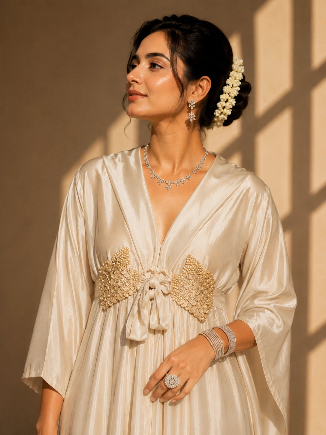 Woman in elegant beige kaftan-style kurti with embellished waist and wide-leg palazzo pants.