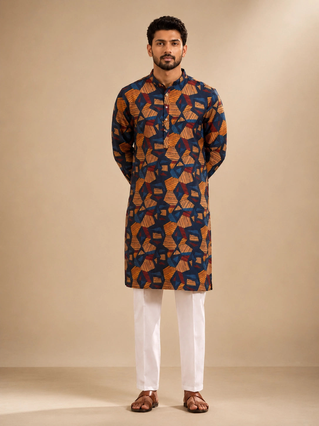 Men's navy kurta with geometric print, paired with white pajama bottoms and brown sandals.