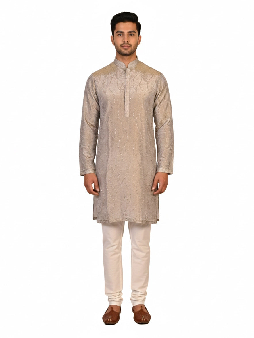 Man wearing a multi-color textured kurta with shimmering accents and cream pants, ready for festive occasions.
